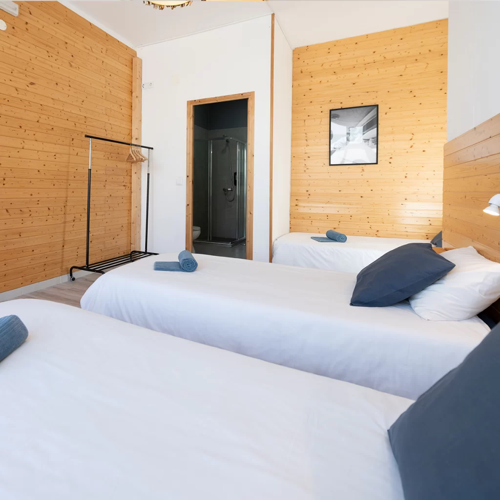 Shared triple male room at Sharks Lodge surf, yoga & CrossFit retreat in Peniche Portugal